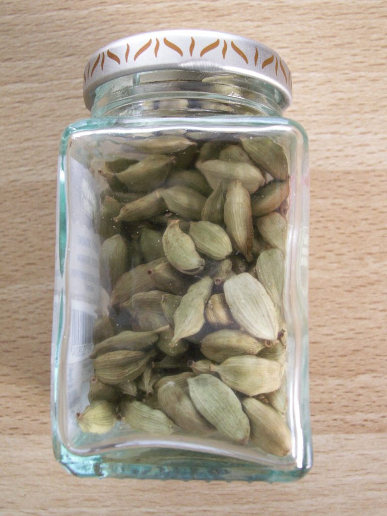 Green cardamom pods — generic product photo, no location claimed; cardamom is not meaningfully grown in Tanzania